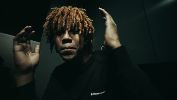 Rich Amari looking surprised with his hands up in the air